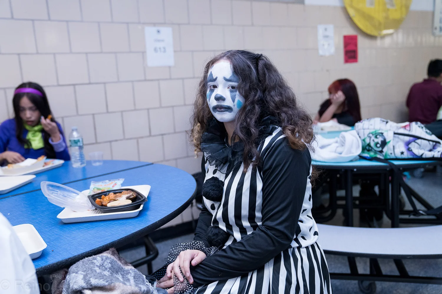 Student in mime costume with face paint at school Halloween event