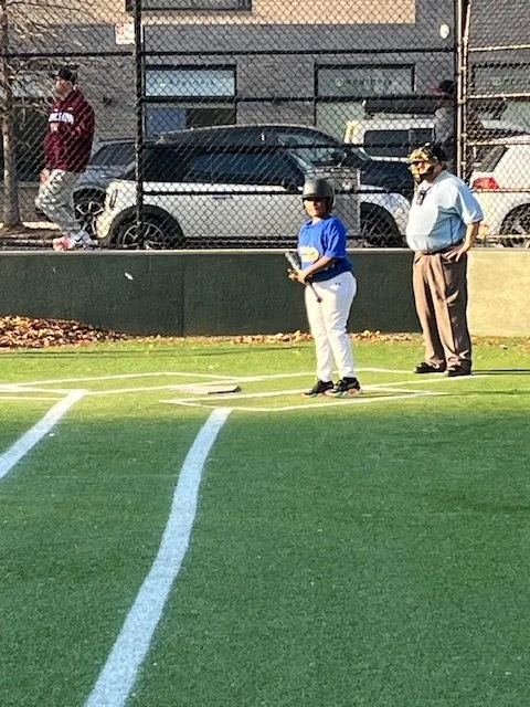 Student batter standing at home plate during baseball game
