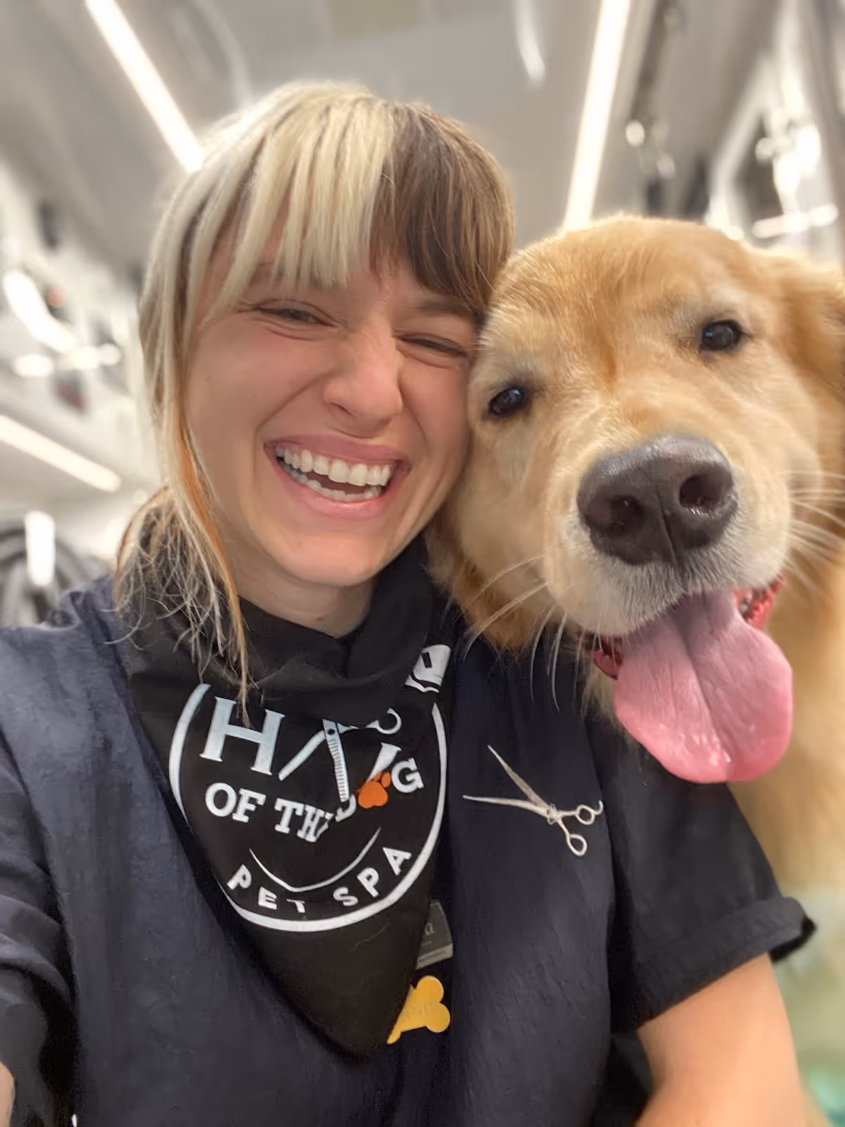 Constance Williams smiling next to a golden retriever