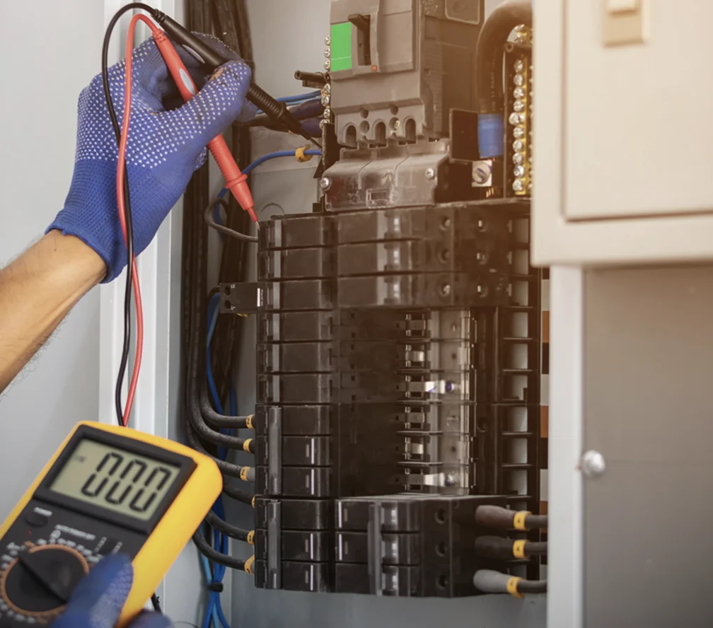 Electrician repairing a panel