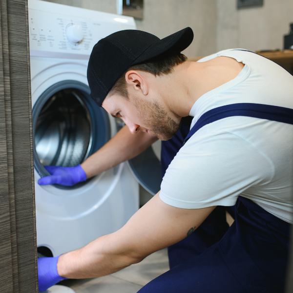 appliance technician inspeting a washer