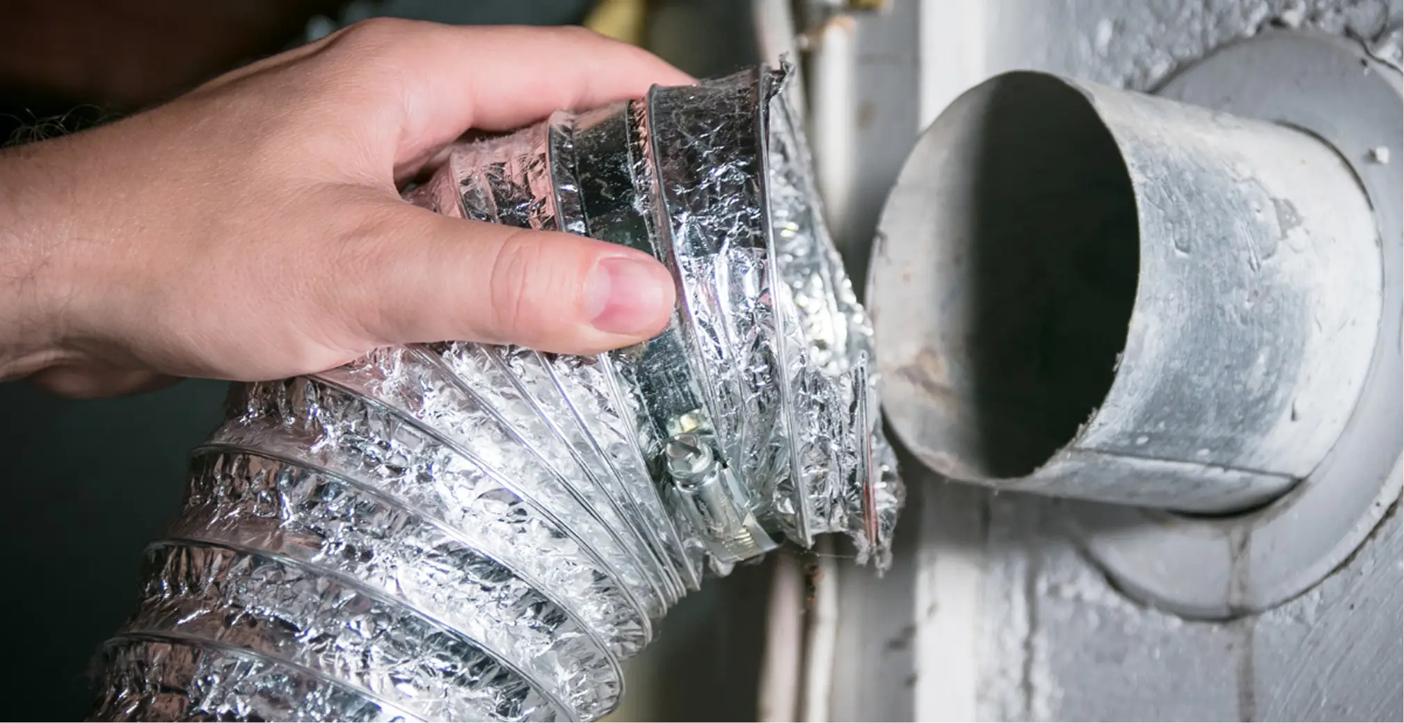 Flexible duct being connected during HVAC inspection