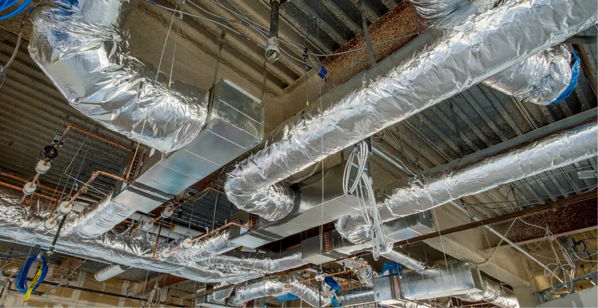 Flexible and sheet metal duct system in a commercial building
