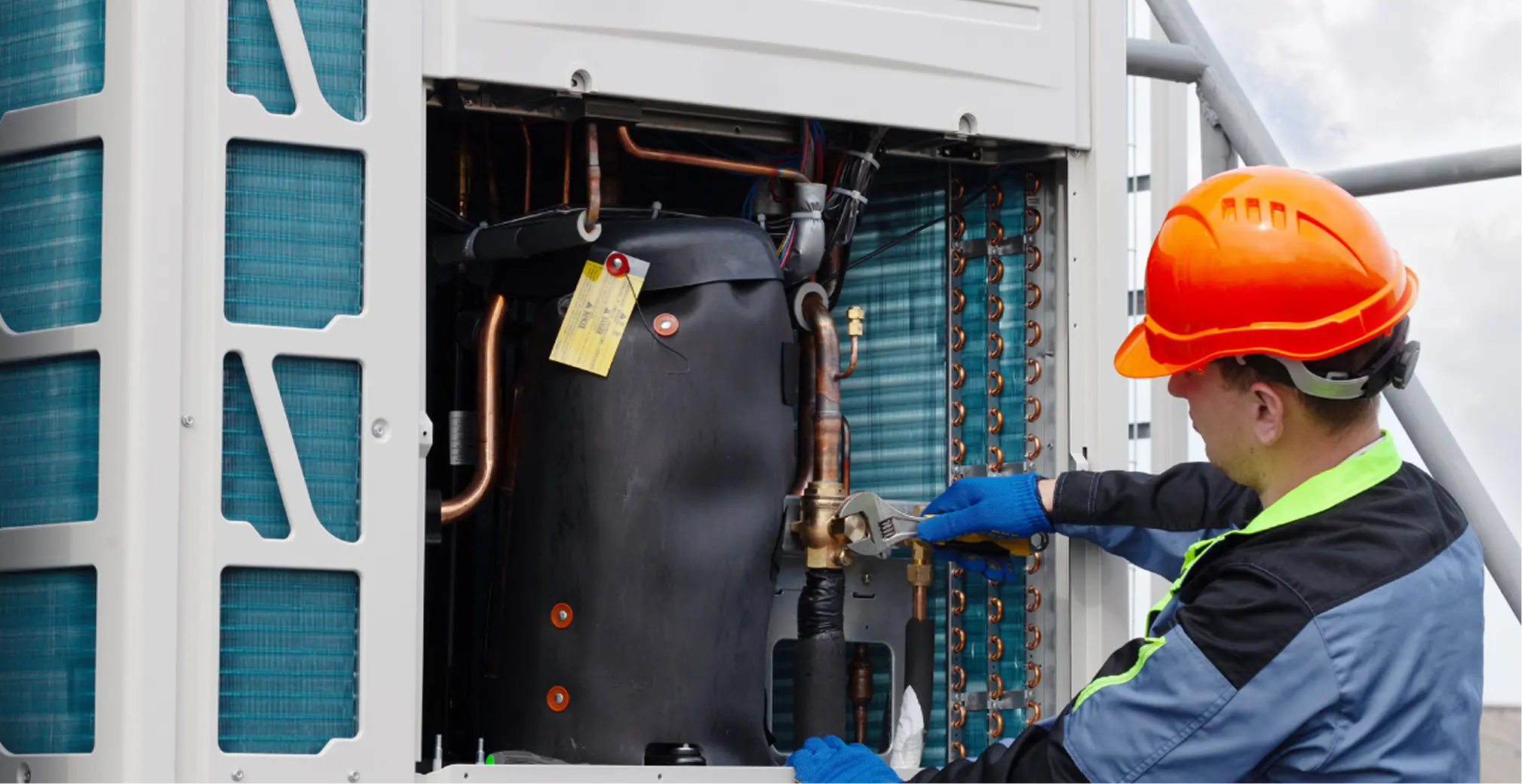 Technician performing VRV system installation and refrigerant connection