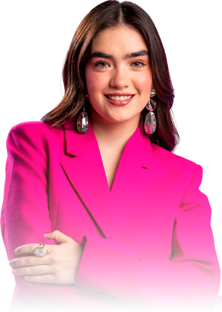 Smiling woman with dark hair wearing large silver earrings and a bright pink blazer, arms crossed.