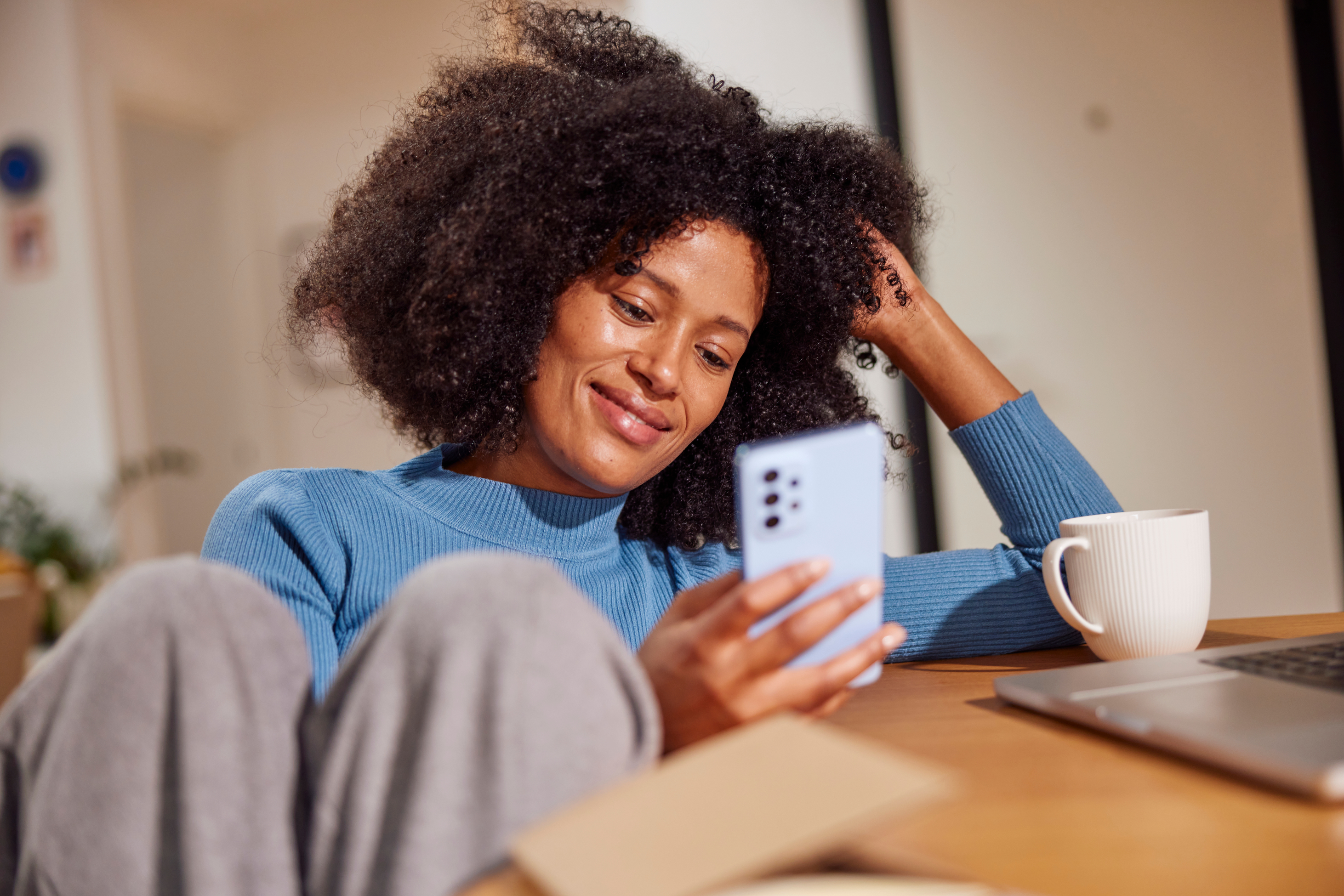 A woman smiling at a phone