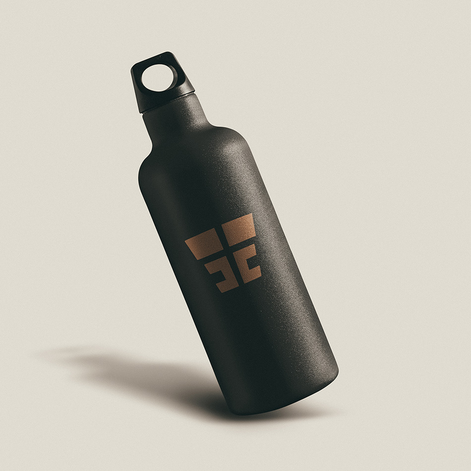 Eddie Estevez Calisthenics promotional water bottle mockup showing black bottle with copper ‘EE’ monogram logo