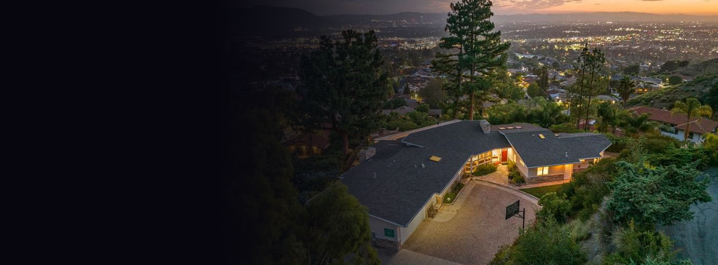 Luxury hillside home listed by Nick Kirby Real Estate featuring panoramic San Fernando Valley views at golden hour