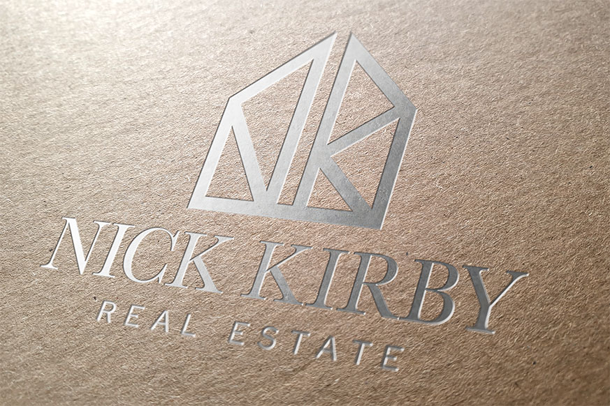 Nick Kirby Real Estate logo engraved in premium material showcasing sophisticated brand craftsmanship and luxury tactile branding