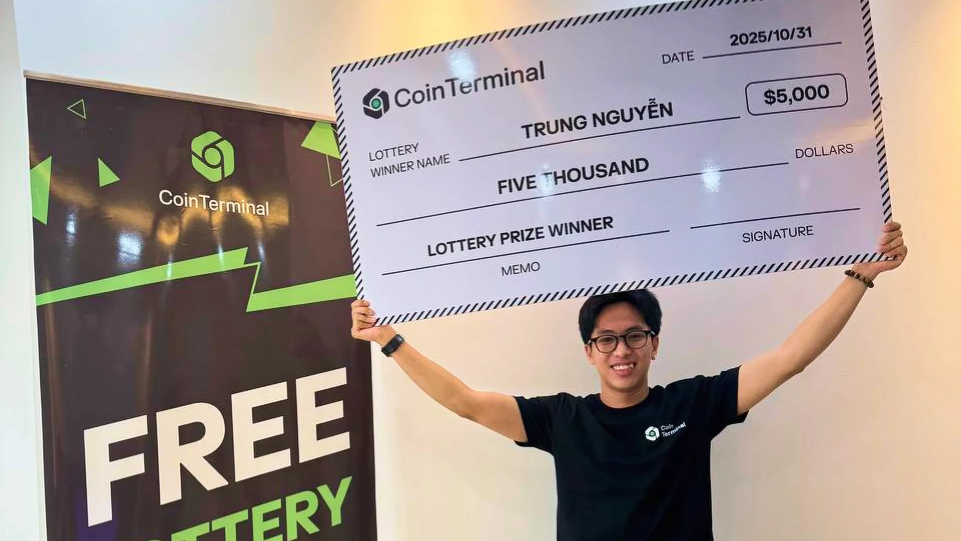 Lottery winner Trung Nguyen holding an oversized $5,000 CoinTerminal prize cheque