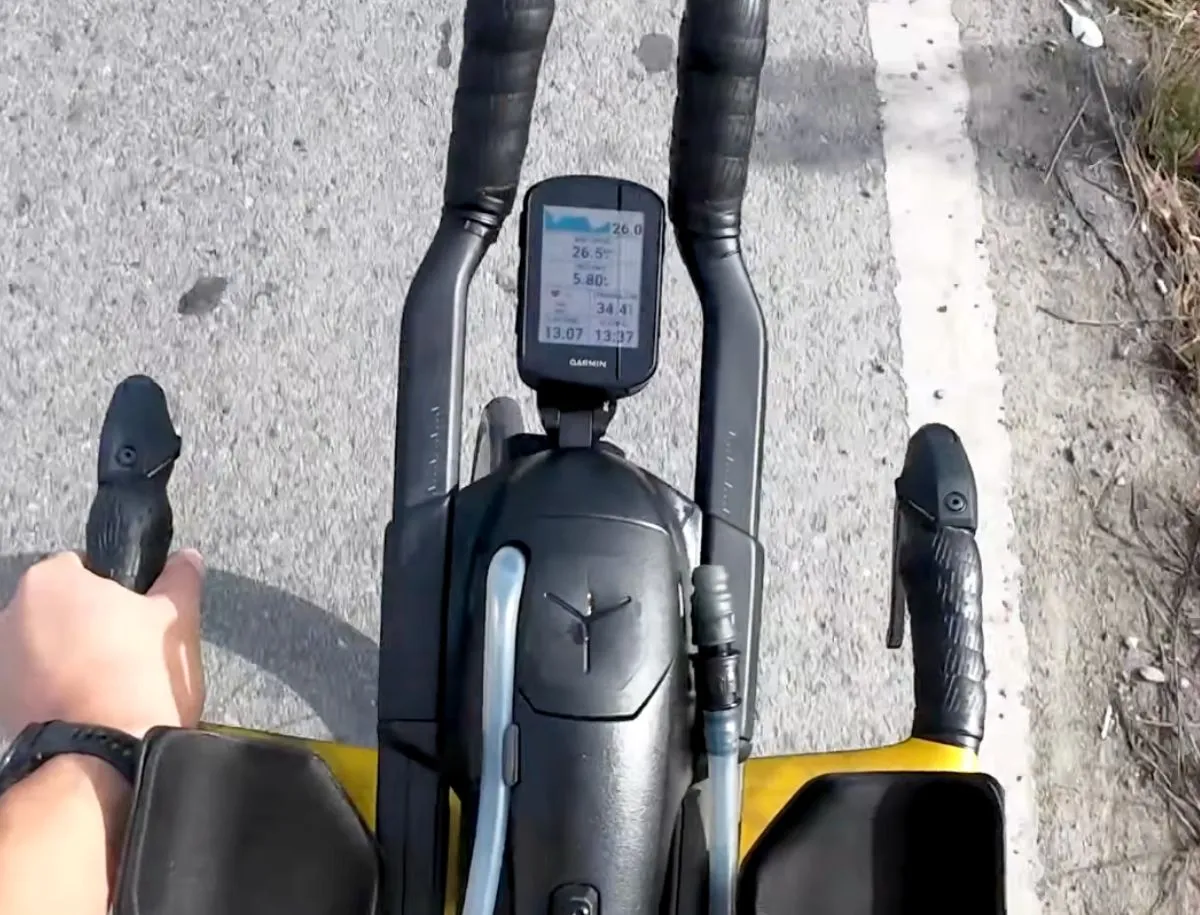 Garmin Edge bike computer mounted on a triathlon cockpit displaying speed, distance, and time data during a ride