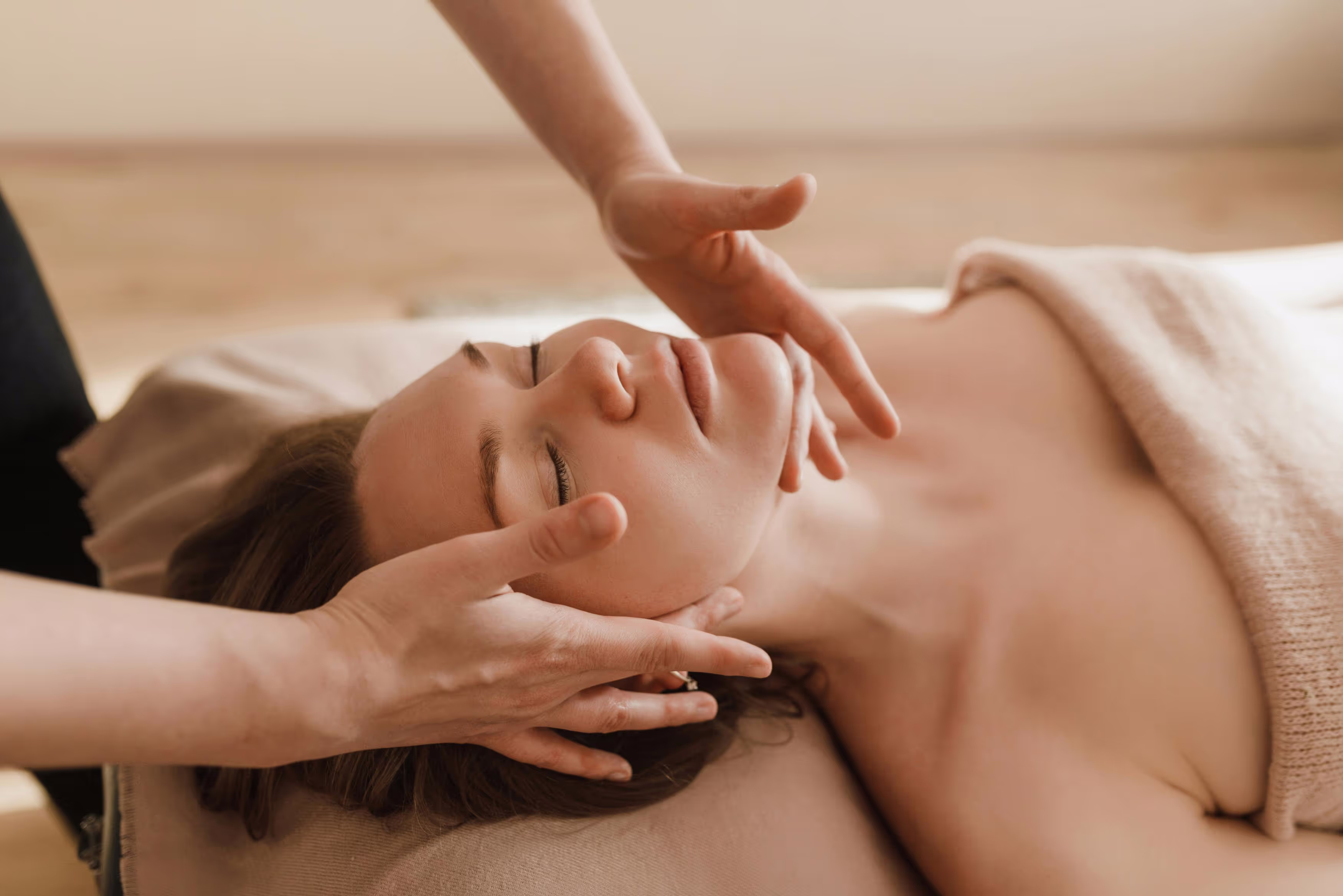 Woman receiving a relaxing face massage at a spa