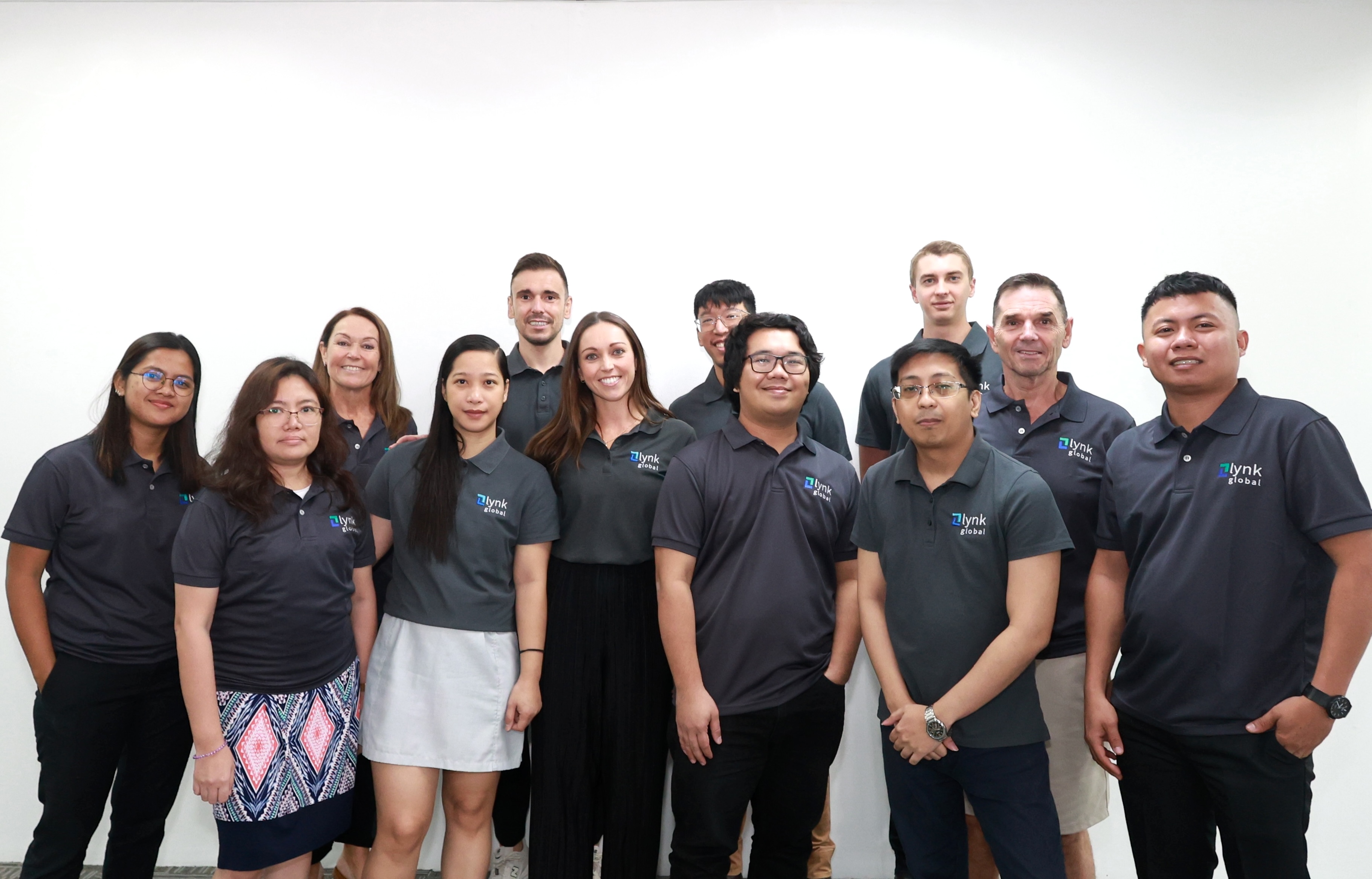 Lynk Global team group photo representing the Australian-managed, in-office support team