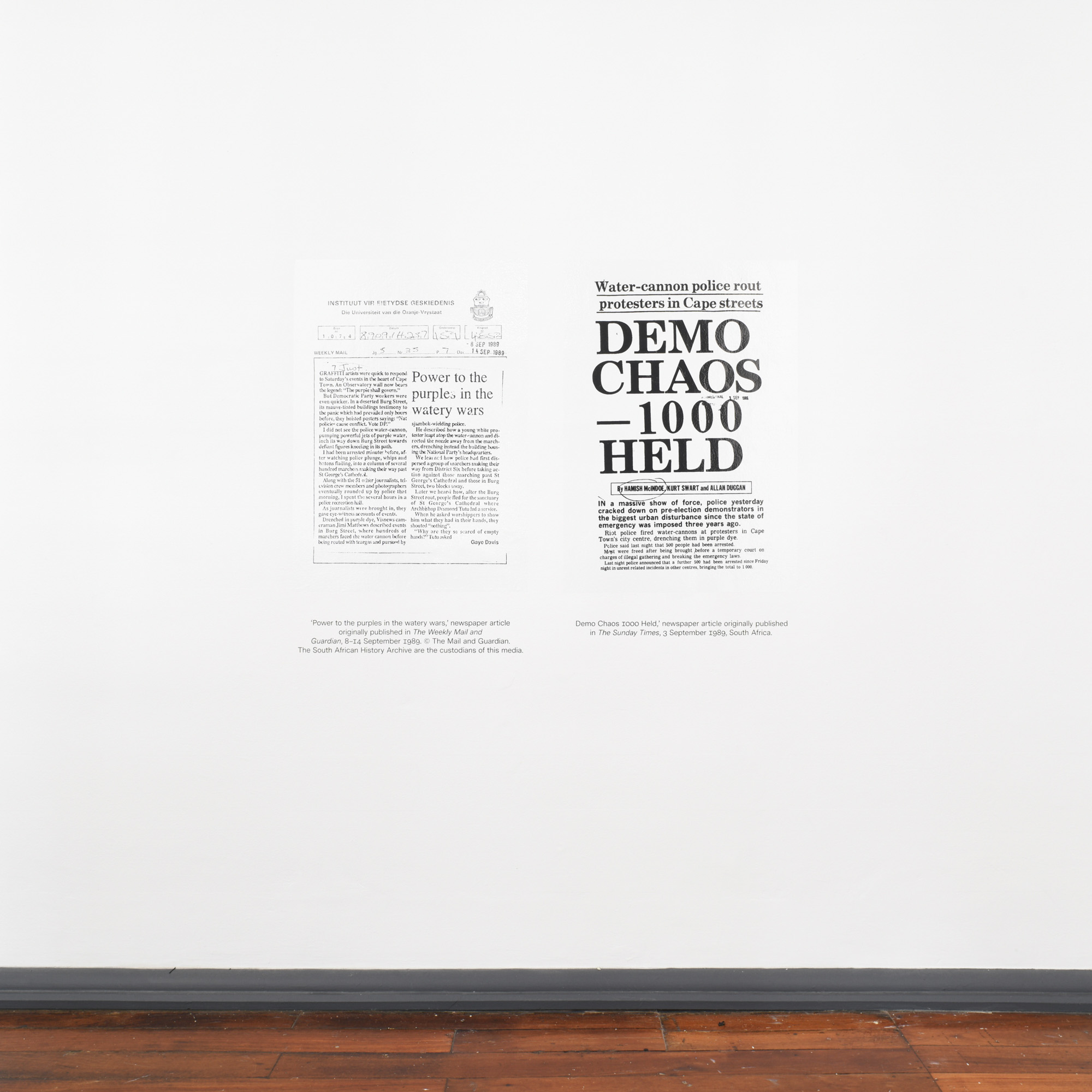 Two archival newspaper articles about Cape Town’s 1989 Purple Rain Protest, with headlines including “Power to the purple…” and “Demo chaos—1000 held.”