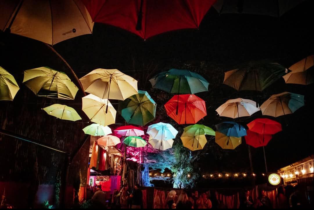 Full Moon Rising festival site covered by coloured umbrellas.
