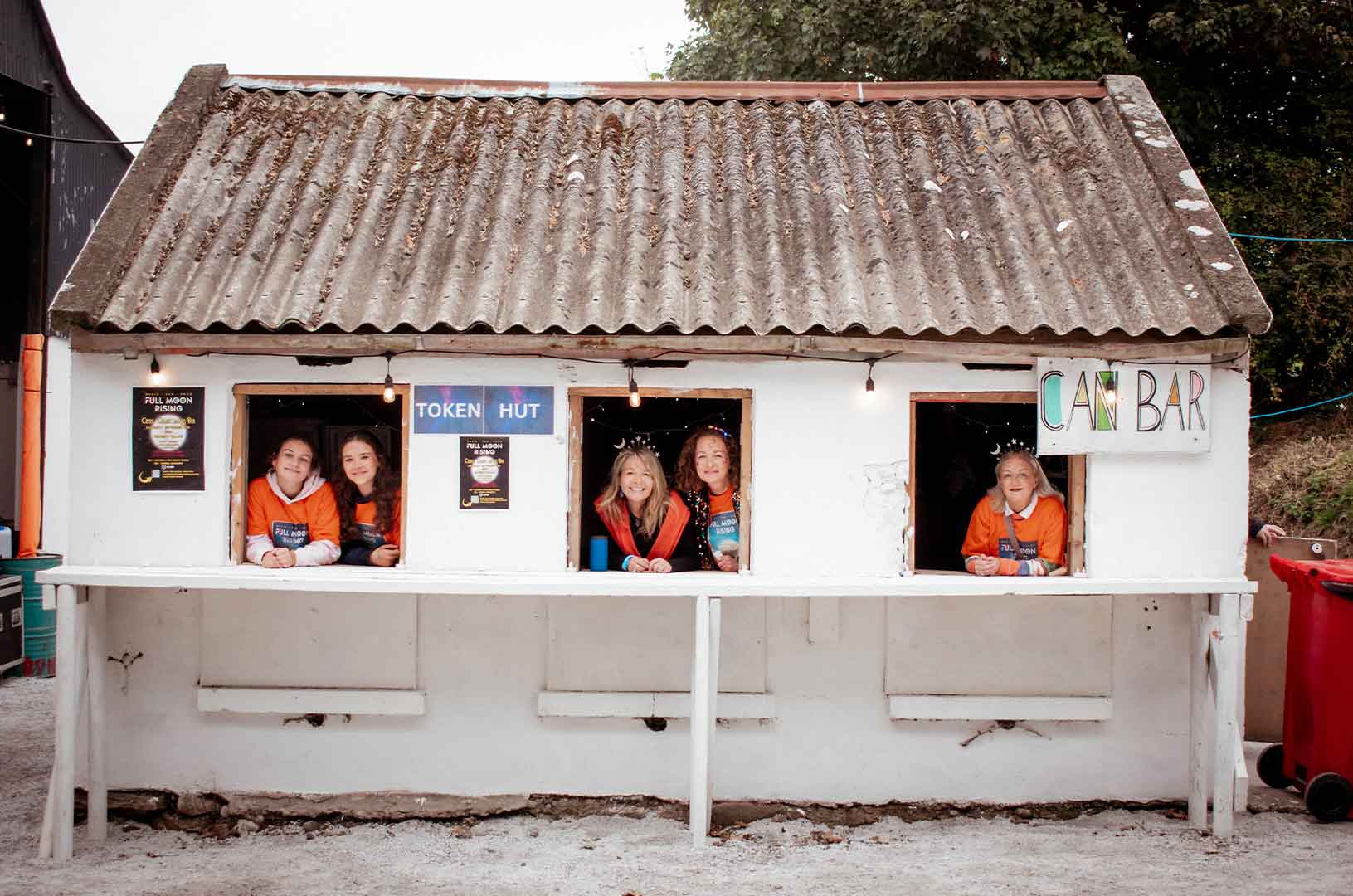 A small cottage with window counters sell Tokens that pay for festival services.