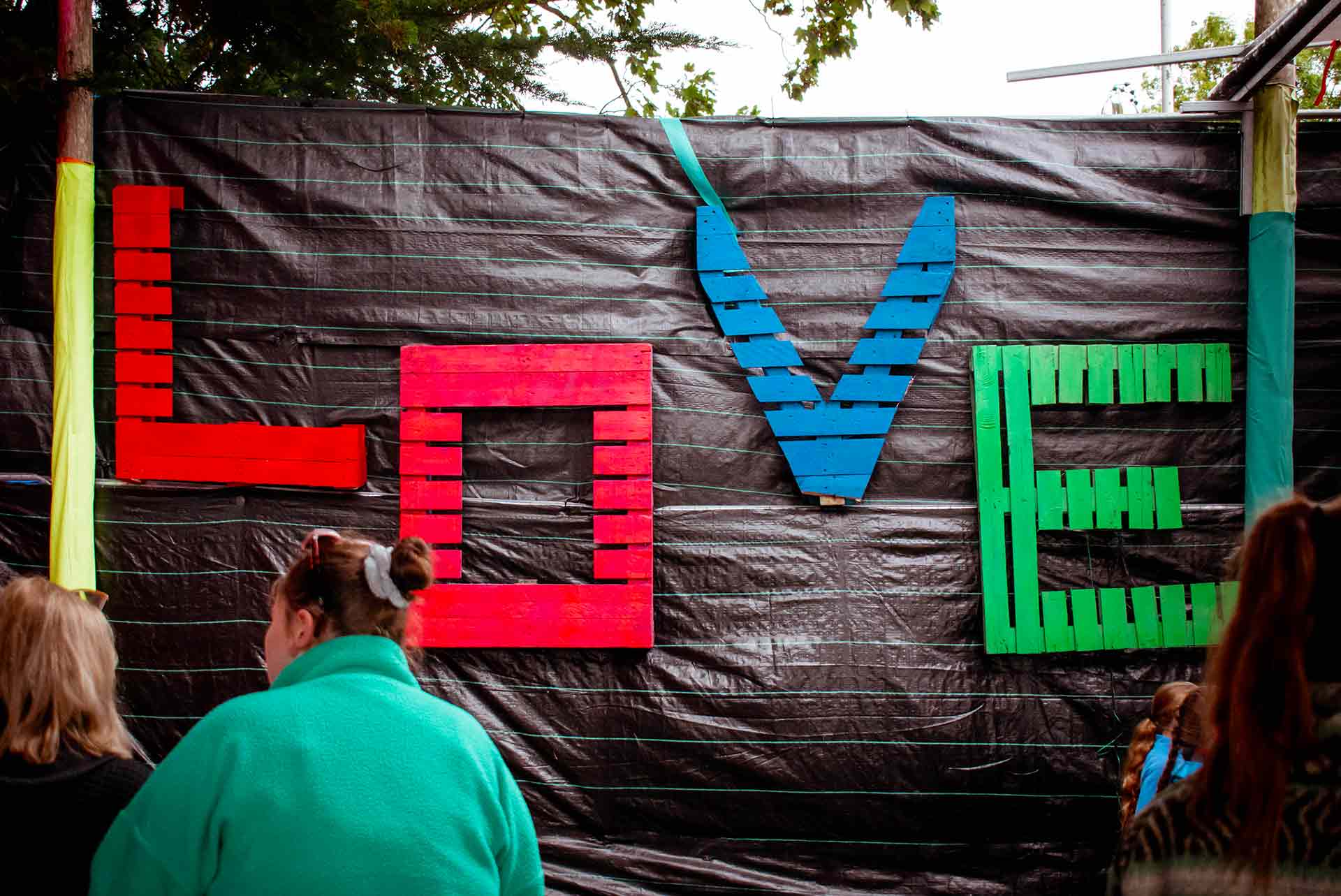 An art installation made out of pallets  with LOVE written in FMR colours