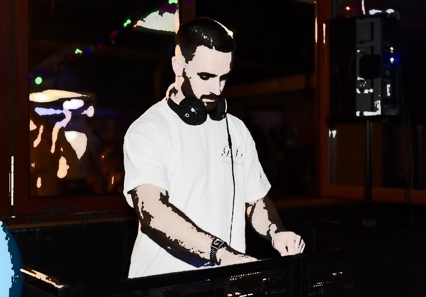 DJ Sean Killeen spinning tunes, headphone around his neck.