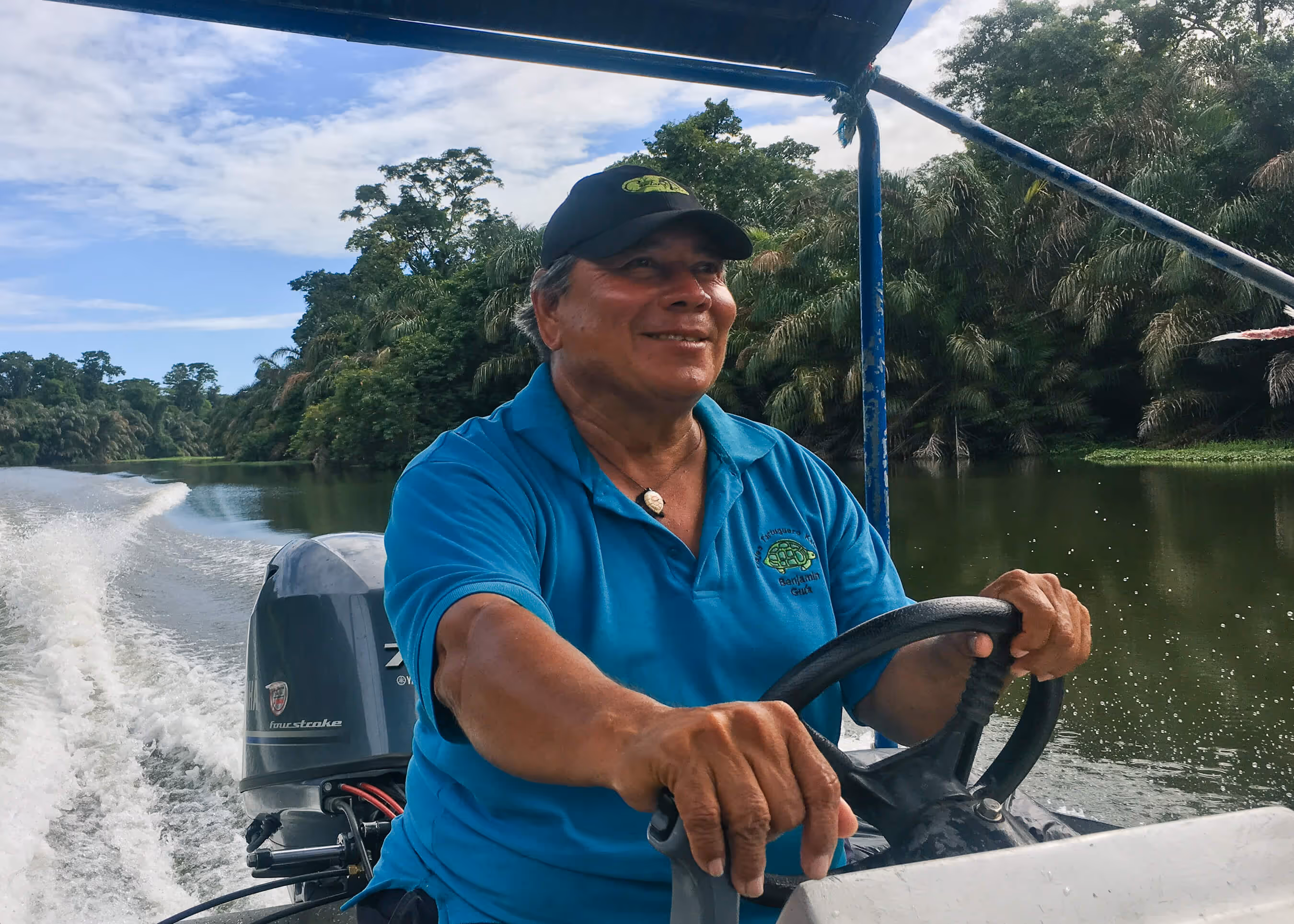 A man driving a boat through the canal in Costa Rica