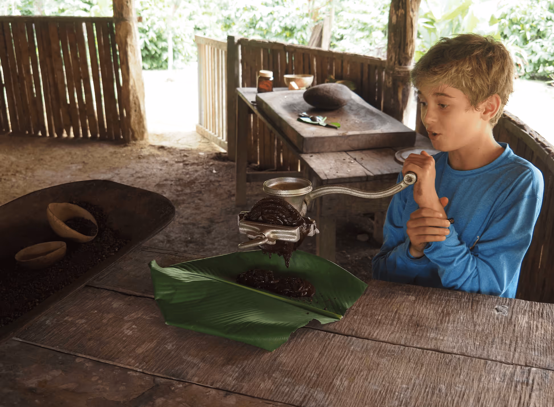 A boy grinding cacao beans to make chocolate.