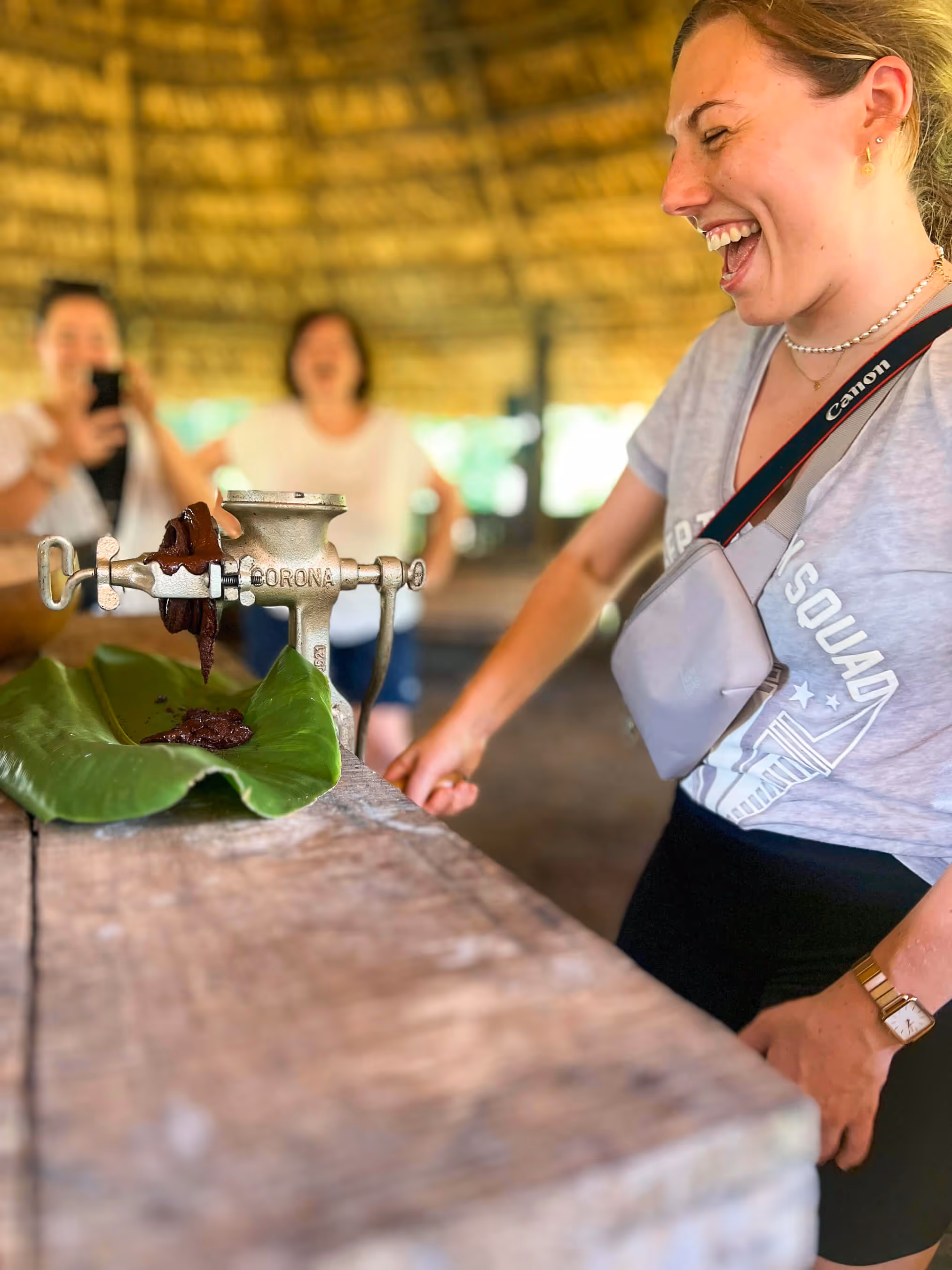 A Sticos guest making chocolate with a special device in and laughing joyfully.