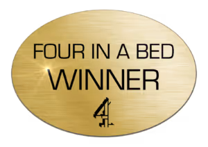 The award logo for winners of the Channel 4 reality TV show "Four in a Bed," given to the best value bed and breakfast or hotel as voted by the contestants.
