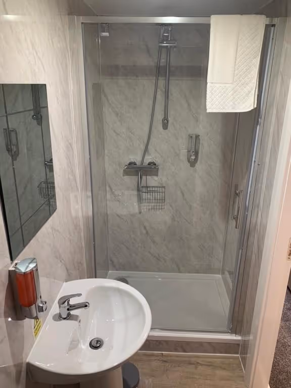 A white bathroom sink with a mirror above it.