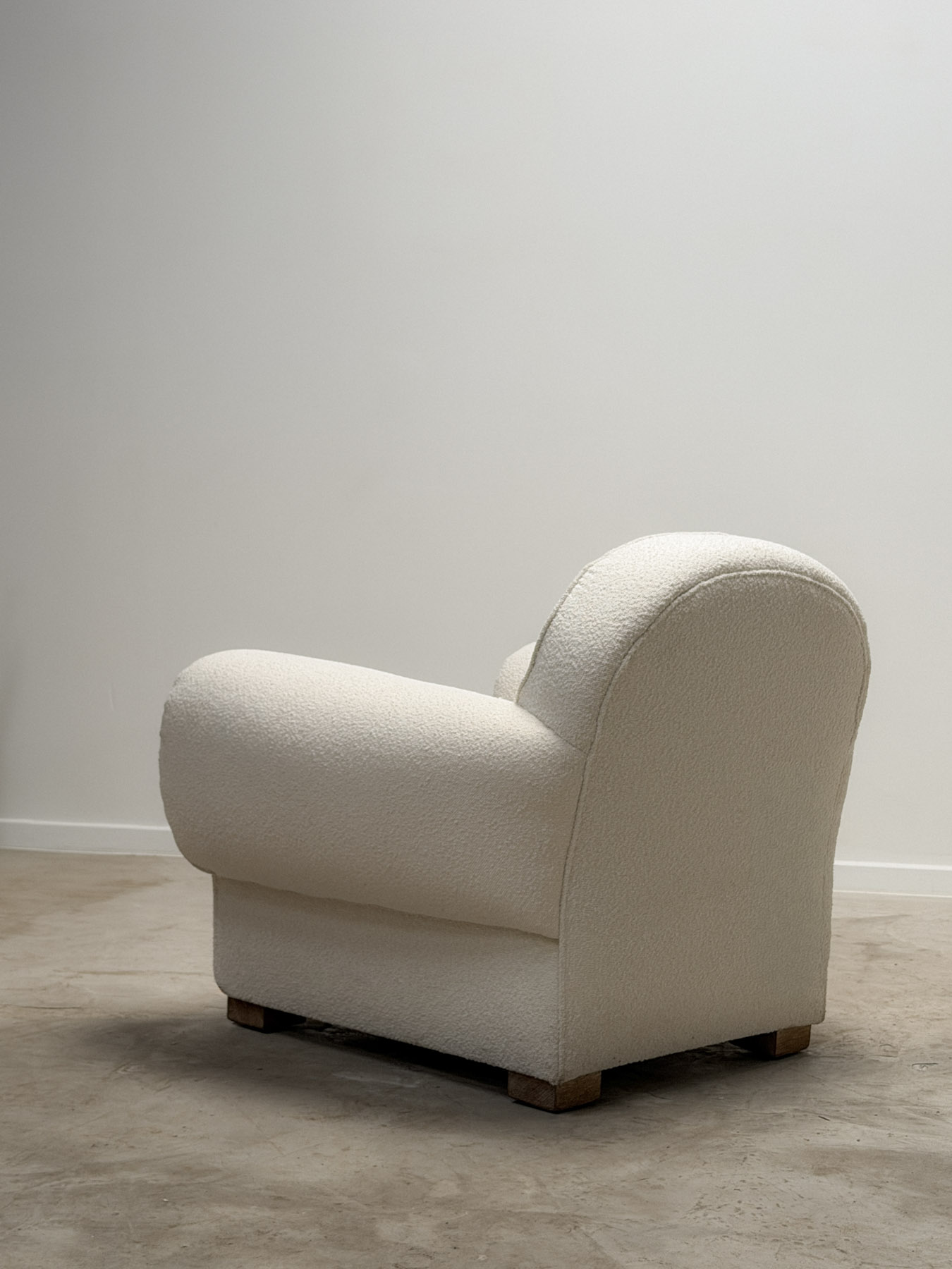 Oversized pair of Art Deco armchairs upholstered in a textured bouclé fabric