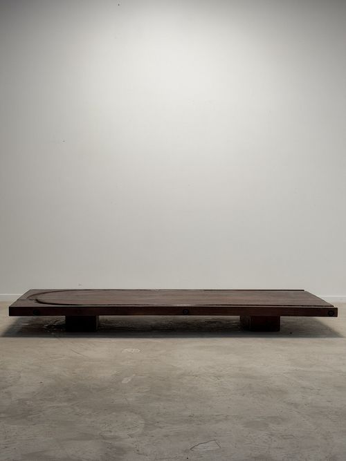 Low coffee table made from an early 20th-century cheesemonger’s board