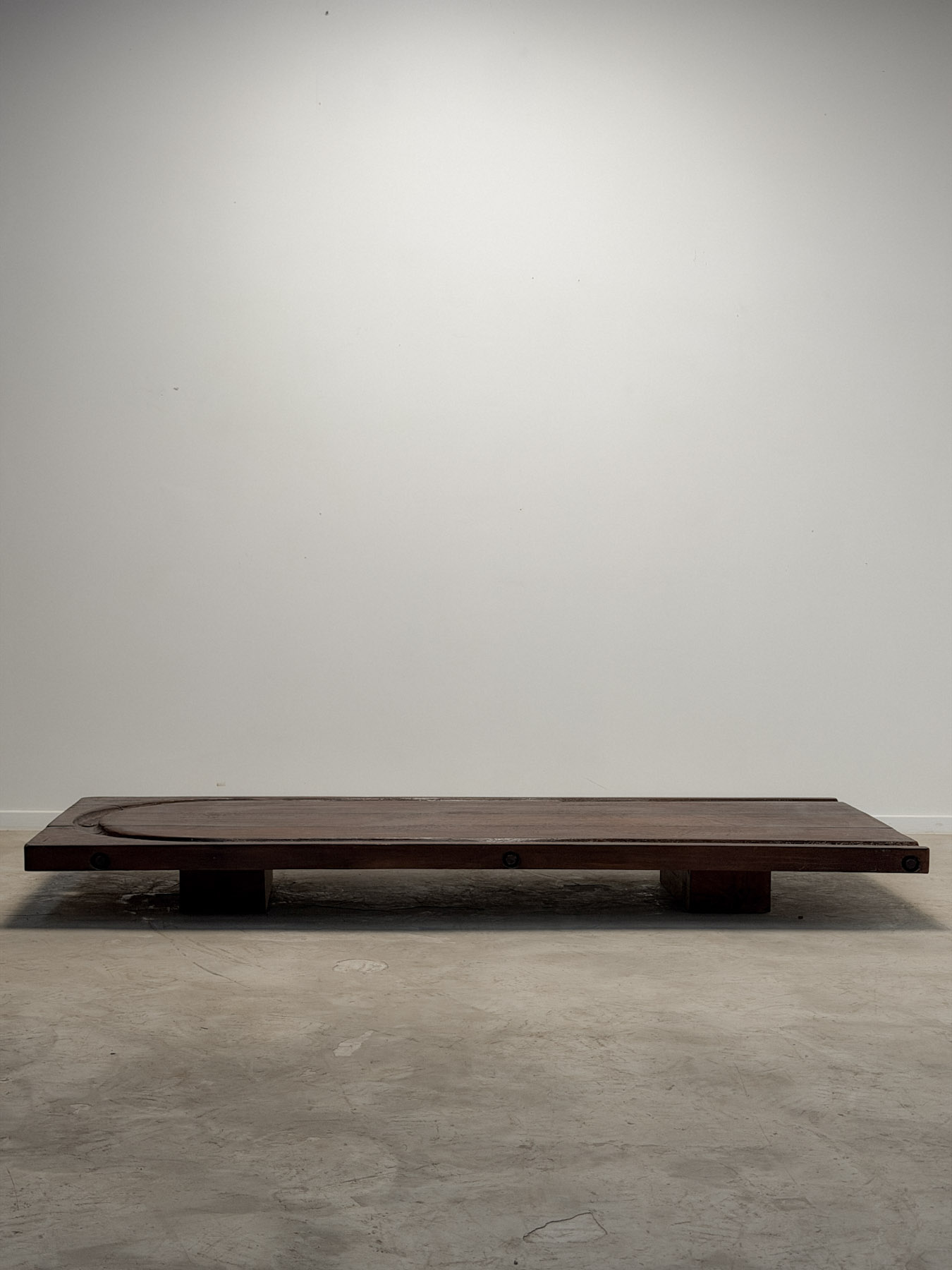 Low coffee table made from an early 20th-century cheesemonger’s board