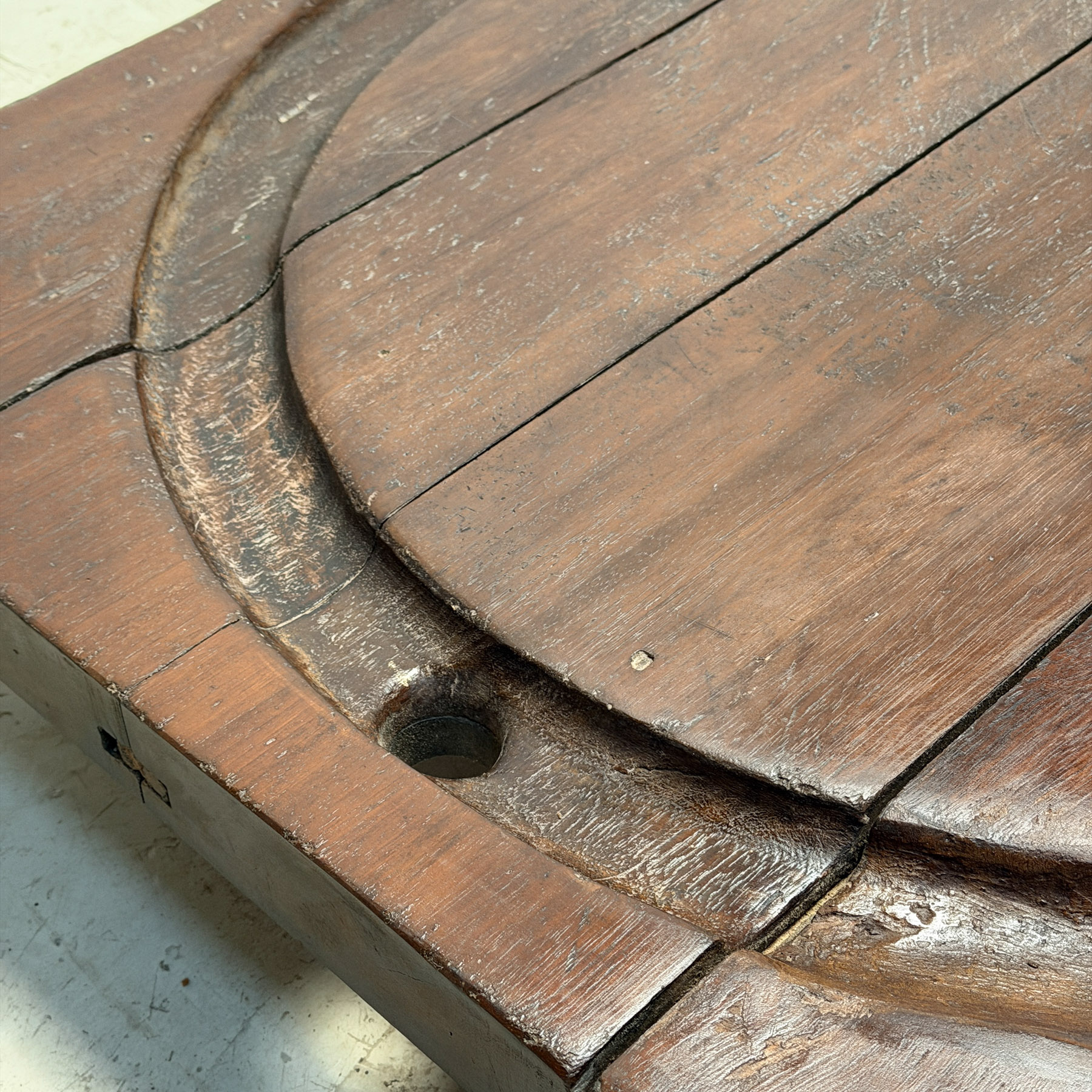 Low coffee table made from an early 20th-century cheesemonger’s board