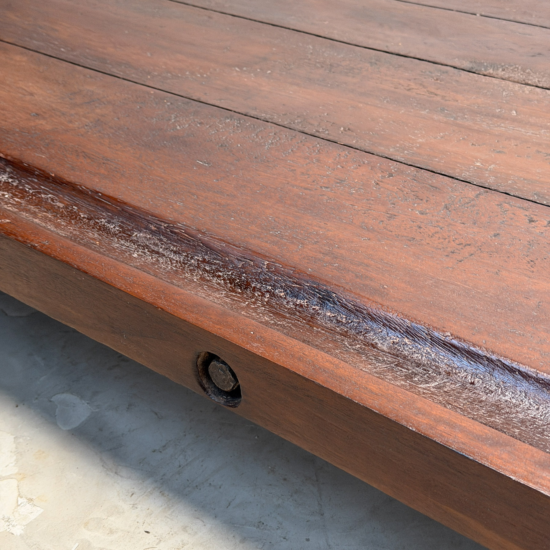 Low coffee table made from an early 20th-century cheesemonger’s board