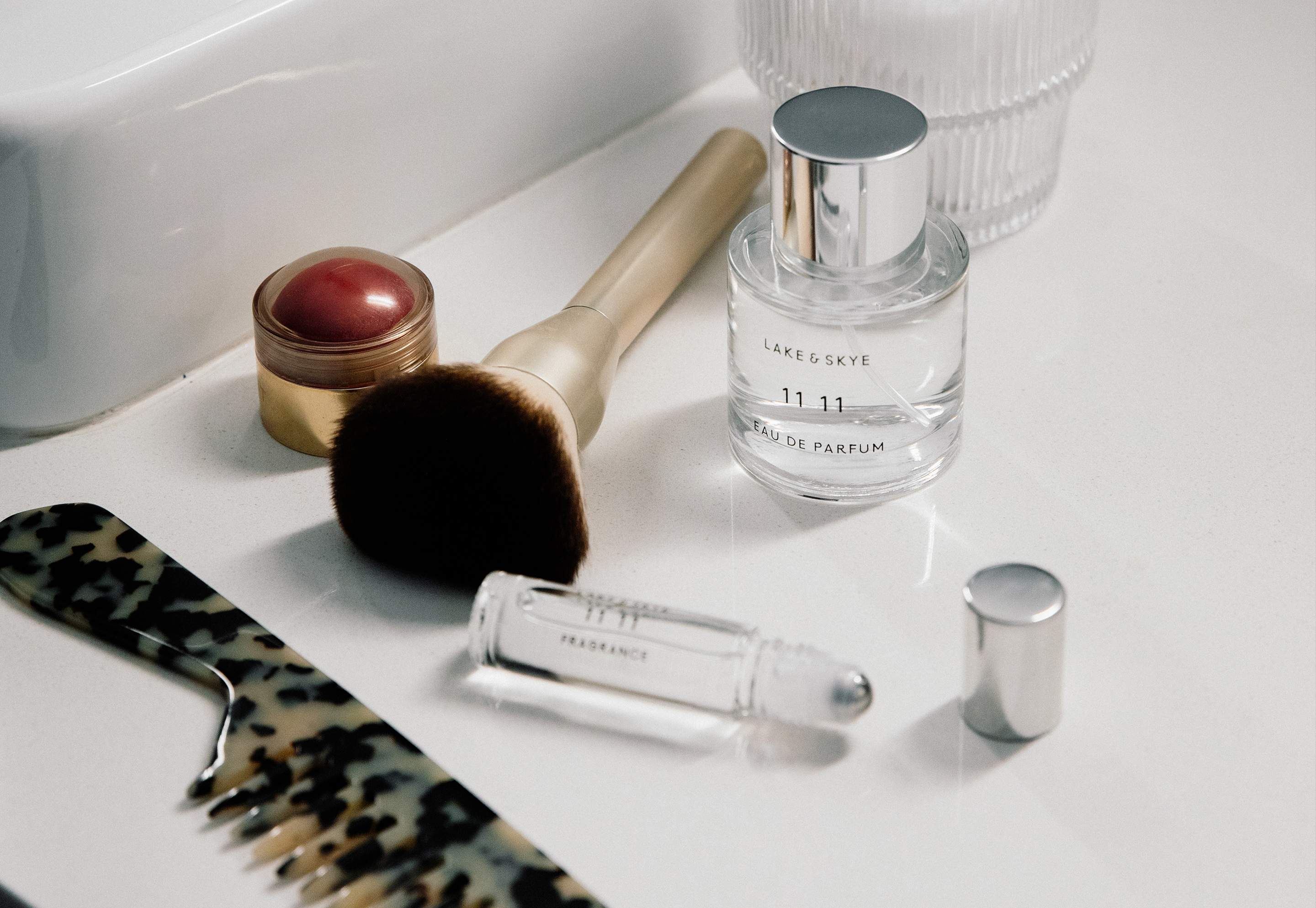 Luxury vanity flat lay with Lake & Skye perfume, rollerball, and clean beauty essentials, editorial photography.
