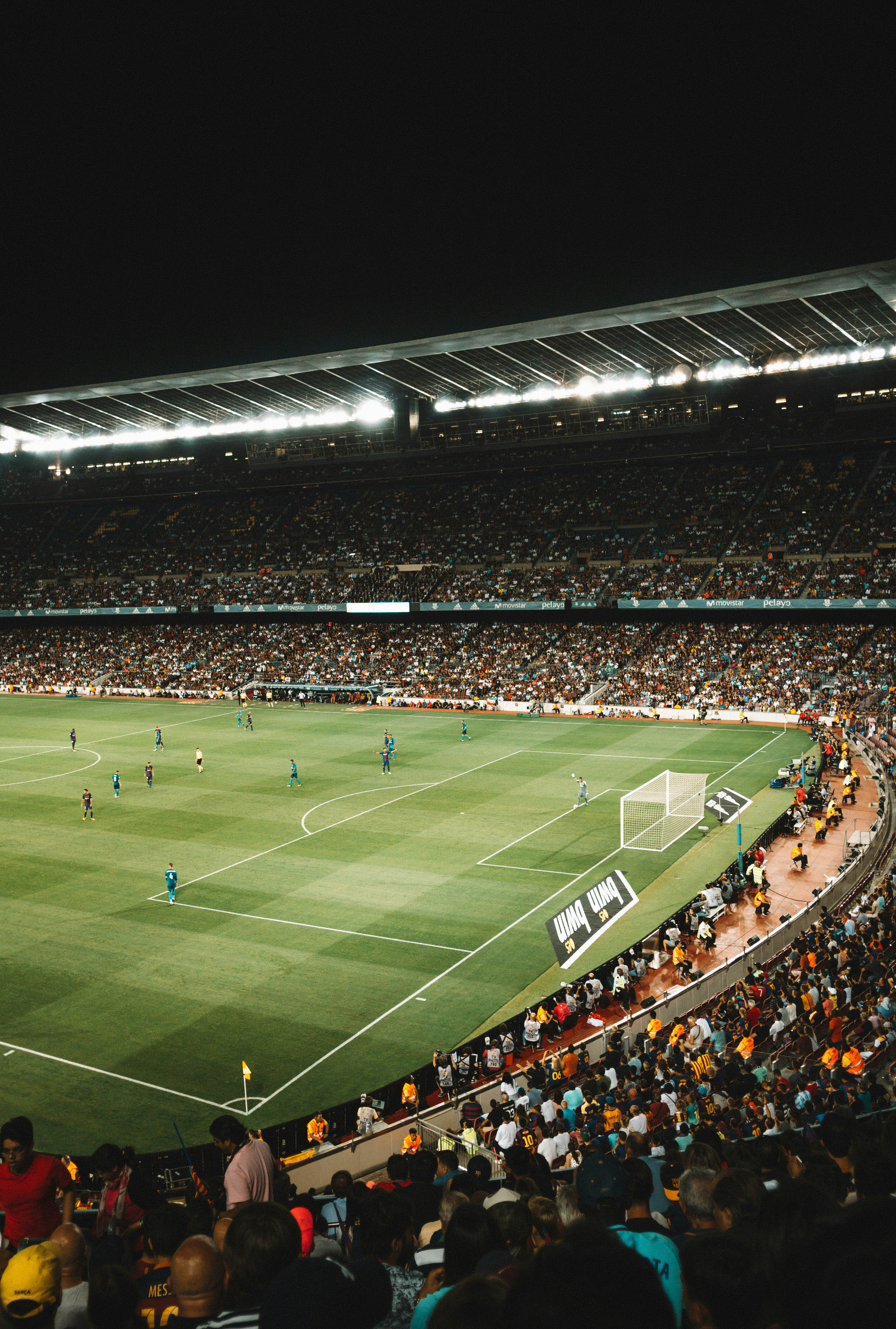 Football stadium at night from behind the corner flag