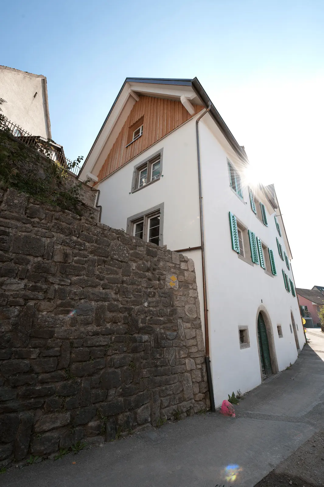 Ansicht des sanierten Dachbereichs mit Holzverschalung am Gebäude in Würenlos