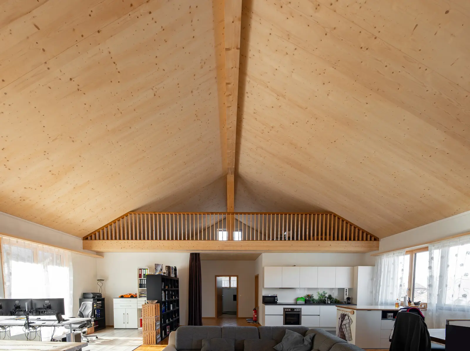 nnenansicht des Dachstuhls im Neubau Rietheim, realisiert in vorgefertigter Holzelementbauweise mit sichtbarer Holzdecke