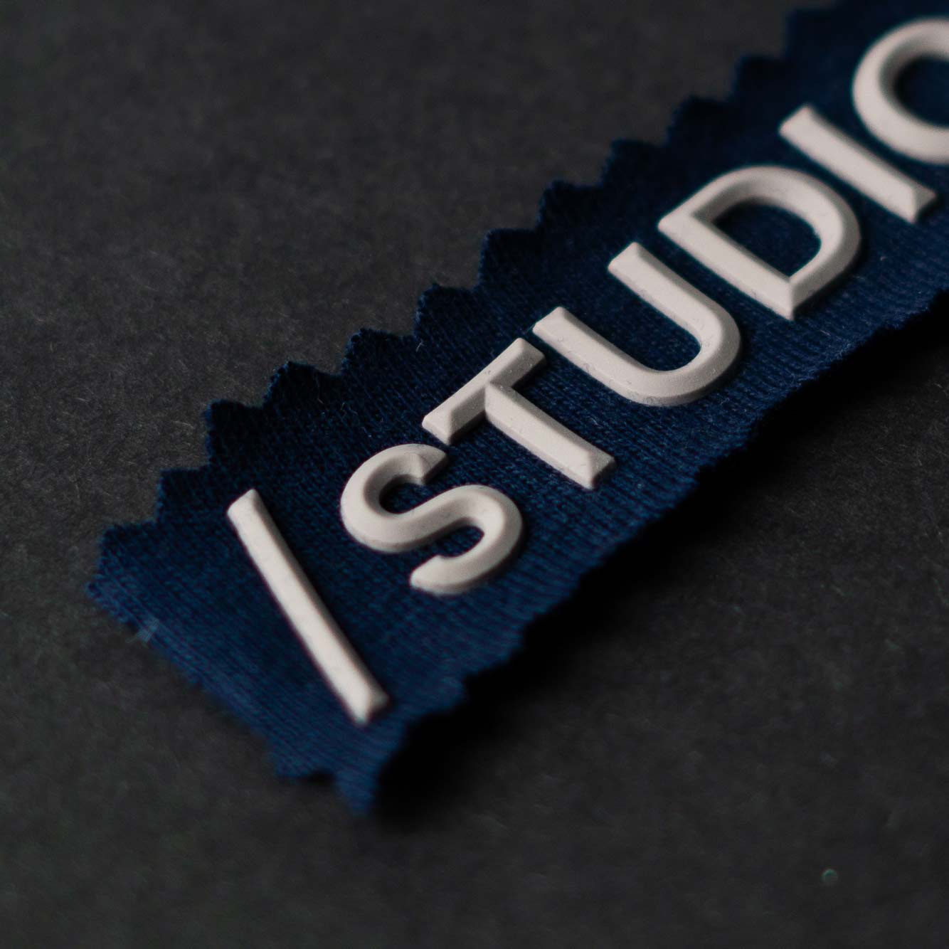 Navy patch with raised white silicone /STUDIOS lettering