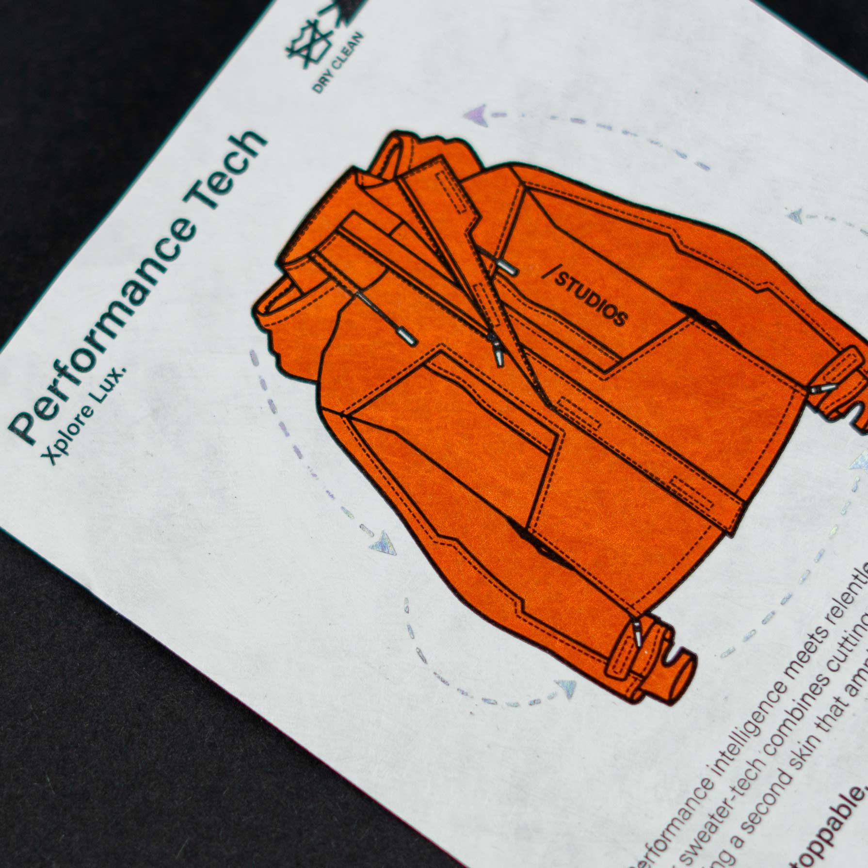 "Performance Tech" label printed with an orange jacket illustration