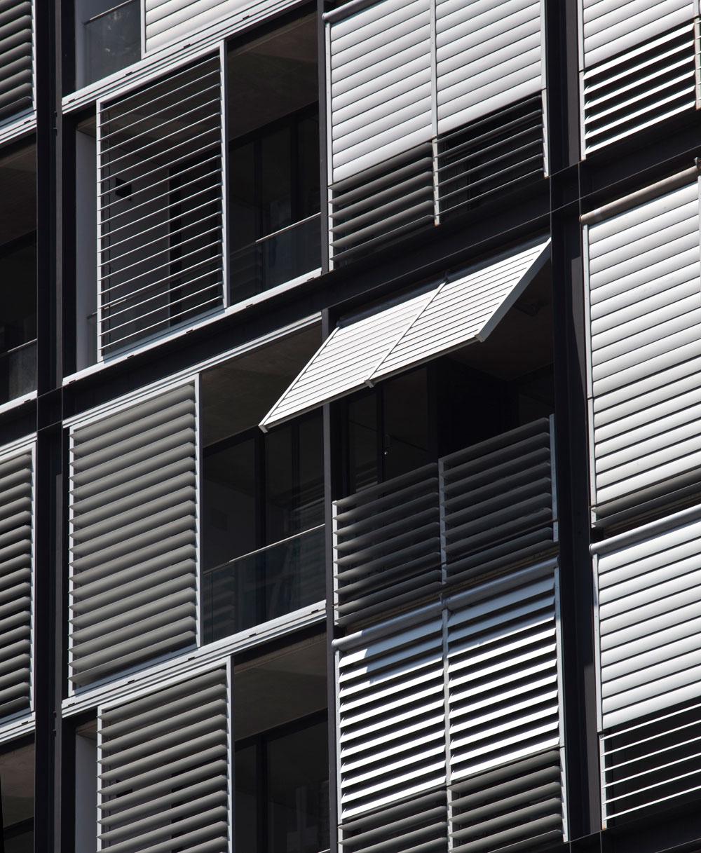black and white image of a facade design with shutters.