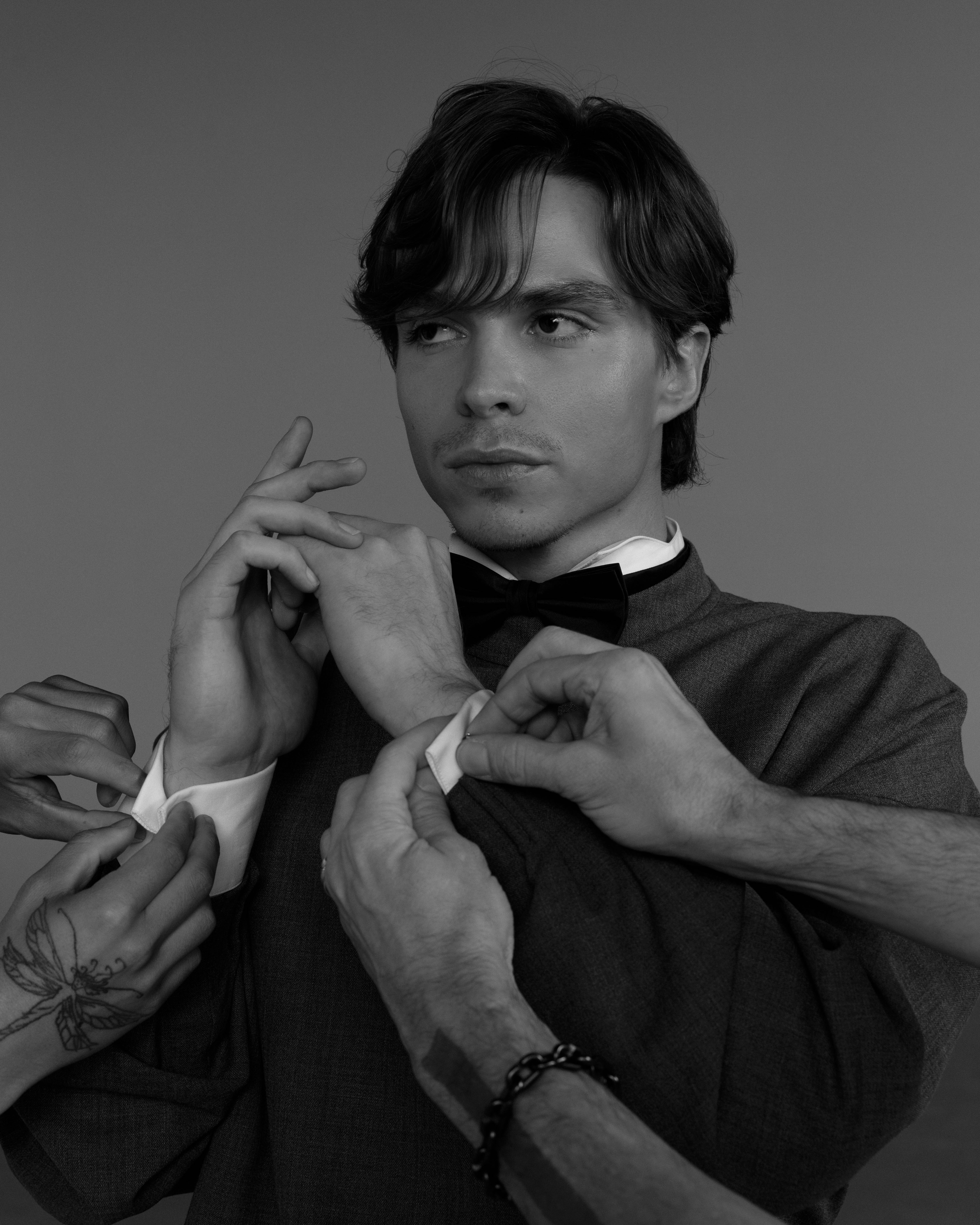 Nicholas Alexander Chavez adjusting cufflinks