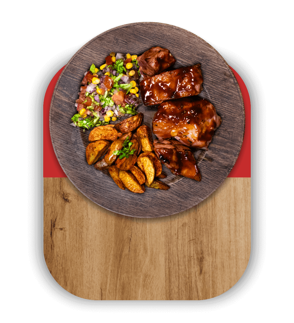 Plato con costillas de cerdo asadas cubiertas de salsa BBQ y un acompañamiento de papas y ensalada de vegetales