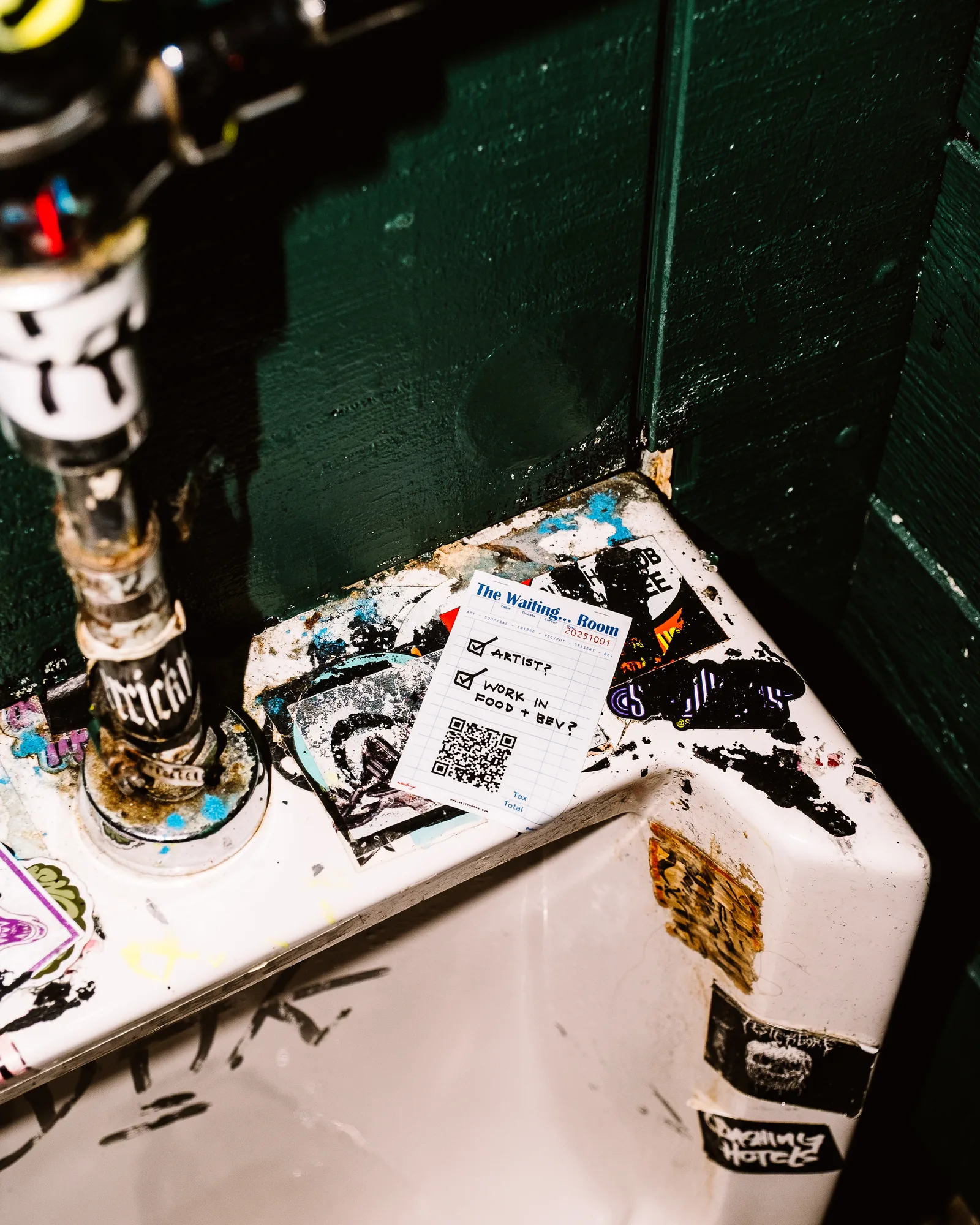 A Waiting sticker in a bar bathroom