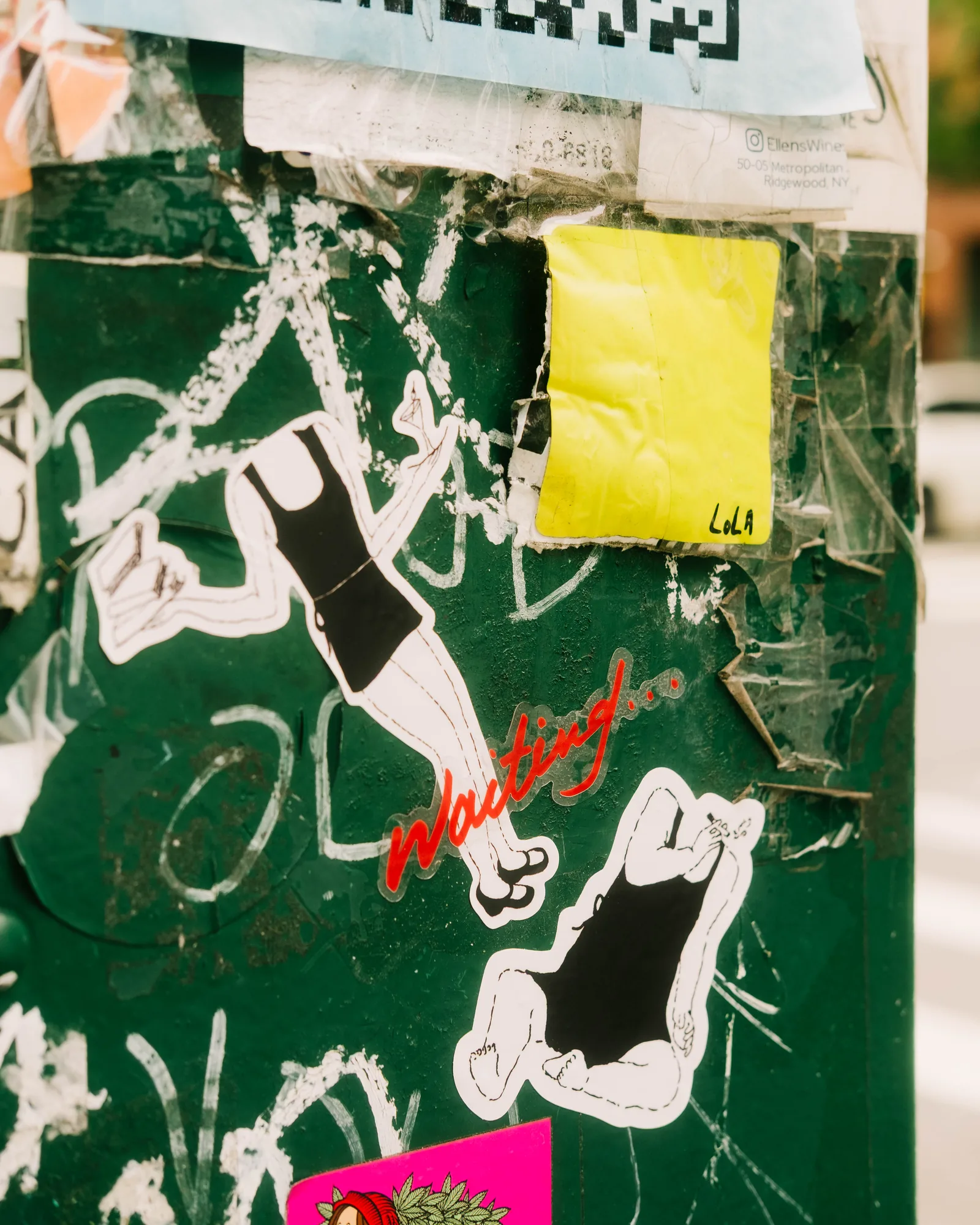 A Waiting sticker on a green utility box