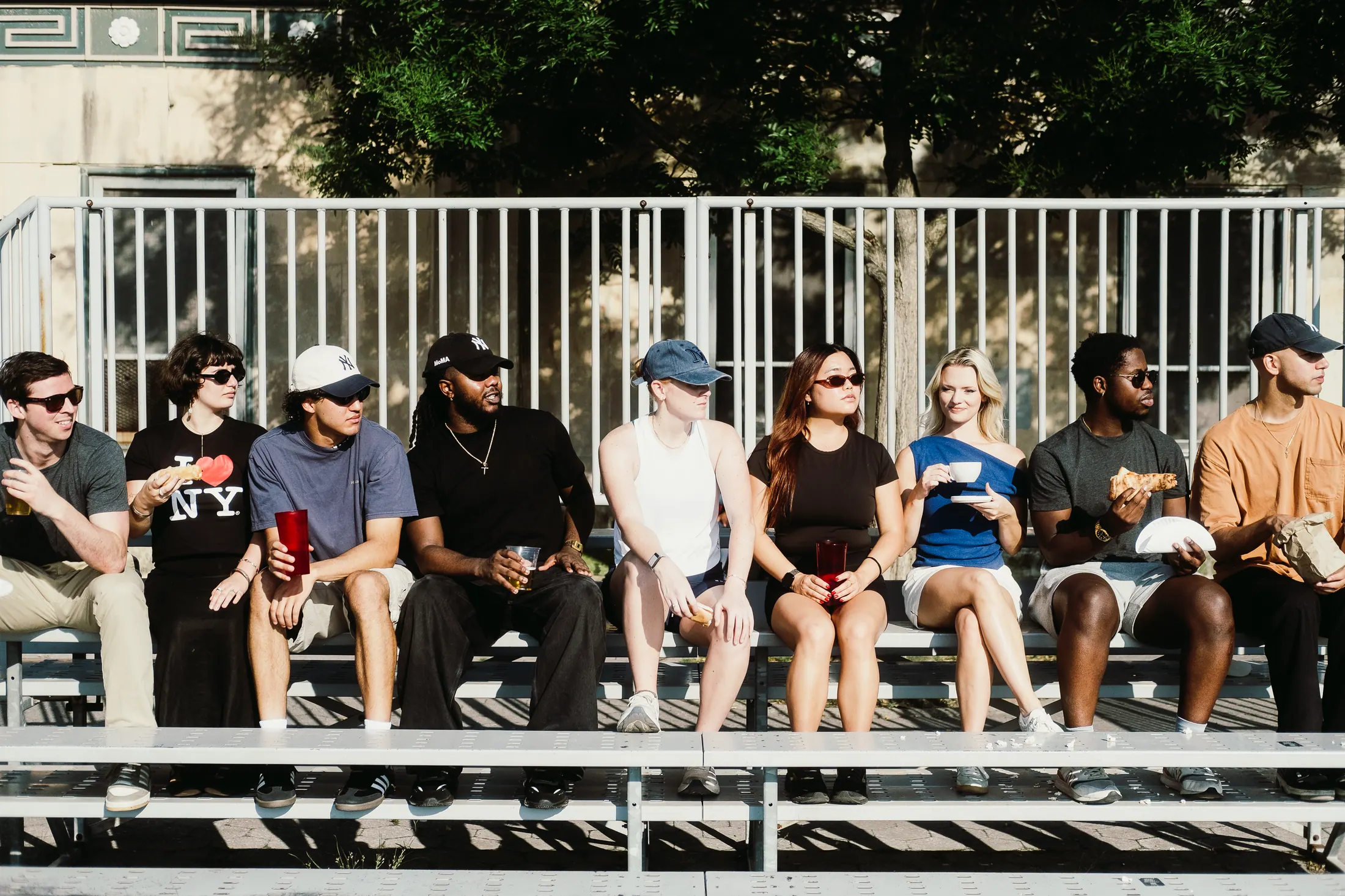 The Edition 2 cast seated together on the bleachers