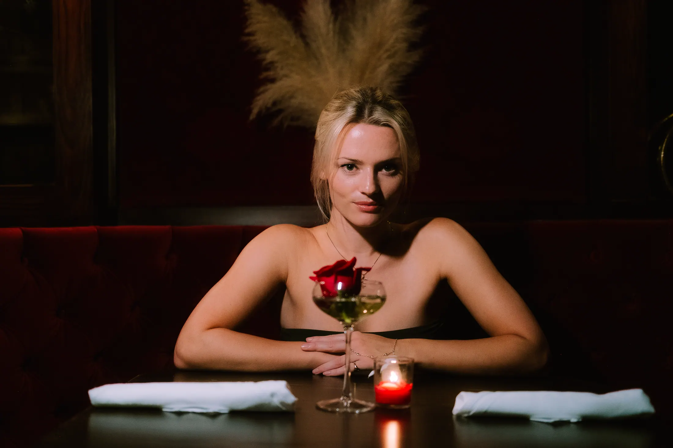 Millie Gibbons at a candlelit table with a rose