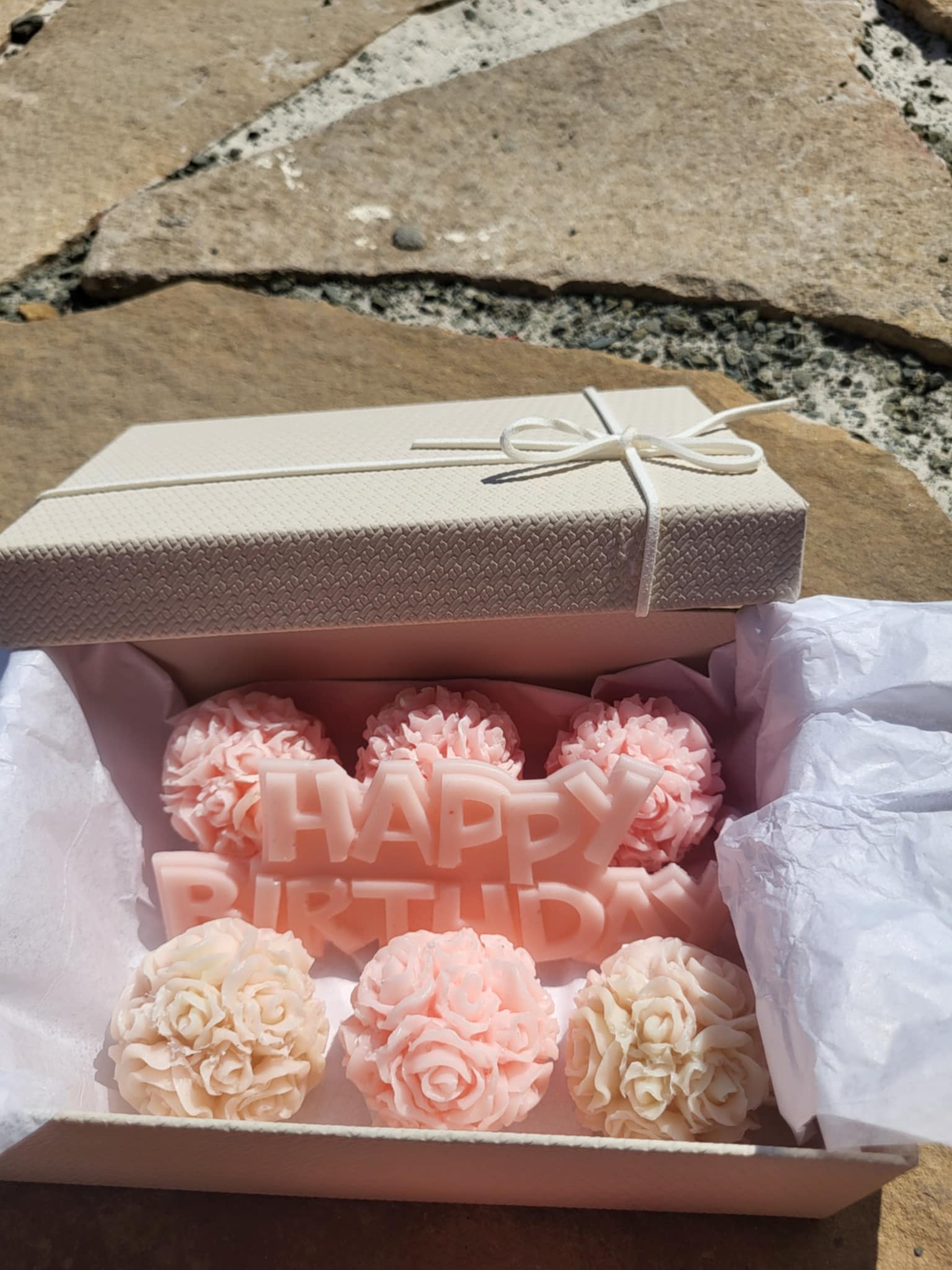 Отворена рожденденска кутия с розови божури сапун, и свещ, която пише Happy birthday