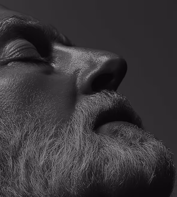 Black and white image of a man with a beard and closed eyes