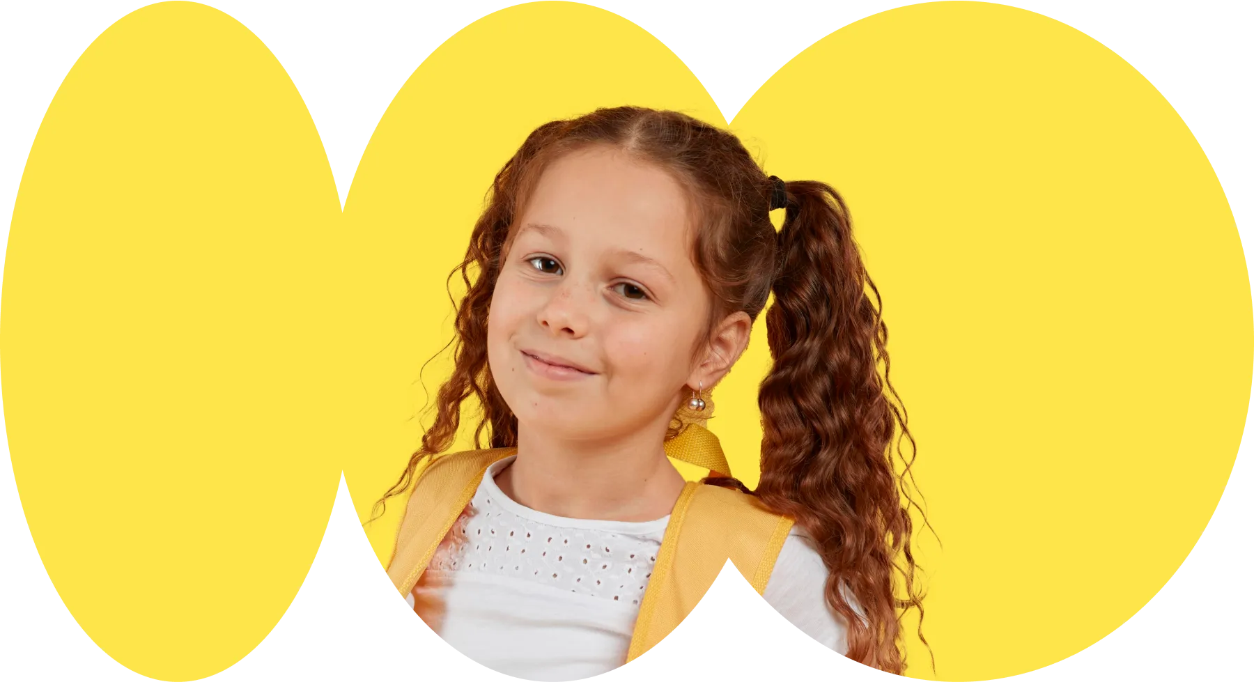 A young girl with long hair wearing a yellow jacket.
