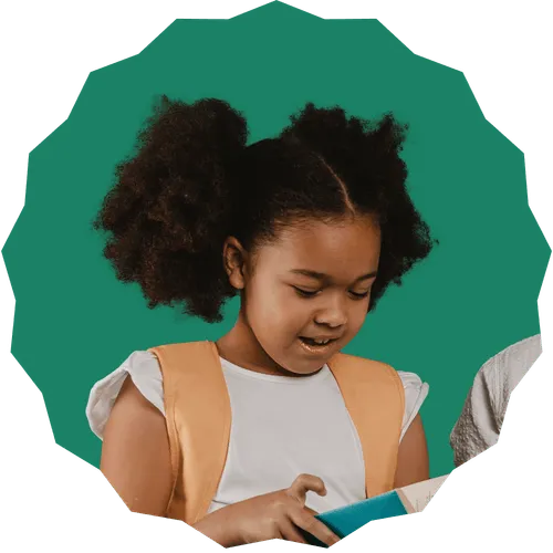 A young girl is looking at a book.