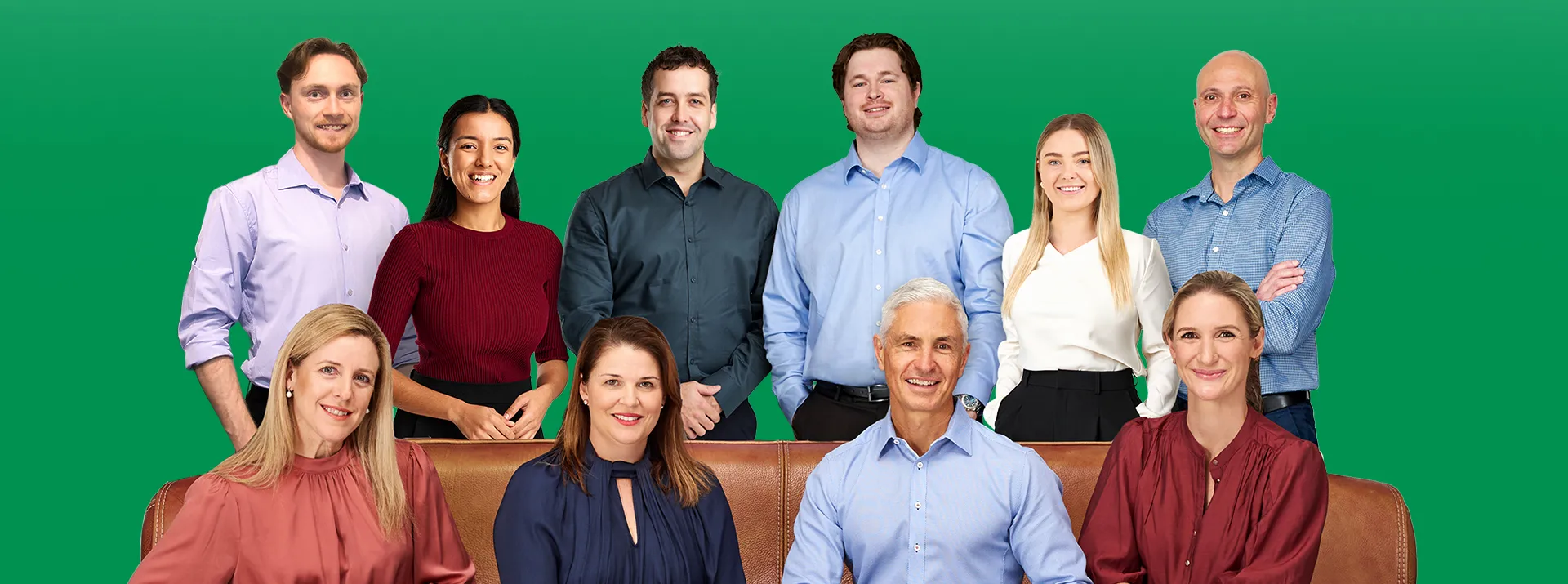 A team of nine Peak Podiatry professionals, some sitting on a couch and others standing behind them.